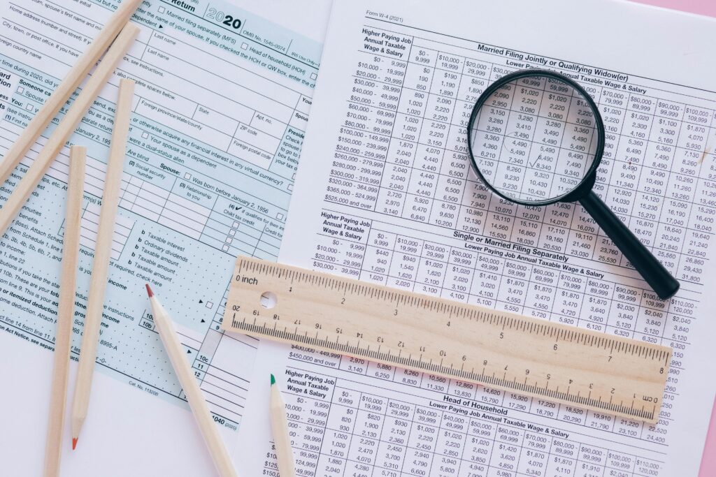 pexels-photo-8970296-8970296 A high angle view showing IRS tax forms with pencils, ruler, and magnifying glass for financial planning.